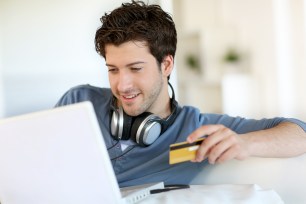 A man researches secured credit cards.