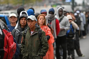 Migrants and asylum seekers line up to enter New York City's immigration center in Federal Plaza in lower Manhattan. They are among the over 100K who arrived in the city in the past year.