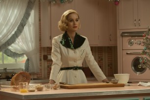 Brie Larson standing in a kitchen.